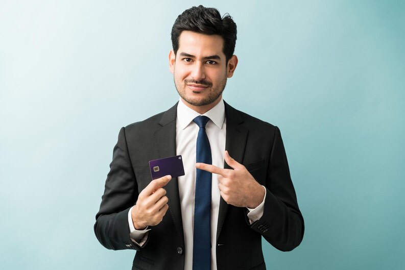 [freepicdownloader.com]-confident-good-looking-male-entrepreneur-pointing-his-credit-card-against-isolated-background-medium.jpg
